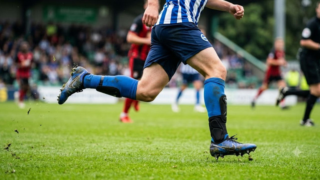 Soccer player wearing shin guards and ankle guards during play.