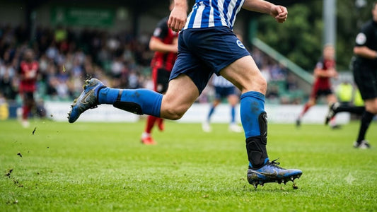 Soccer player wearing shin guards and ankle guards during play.
